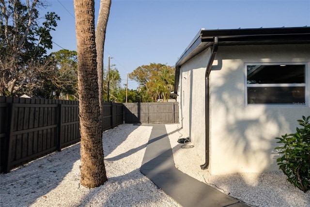 view of home's exterior featuring a fenced backyard, a patio, and stucco siding