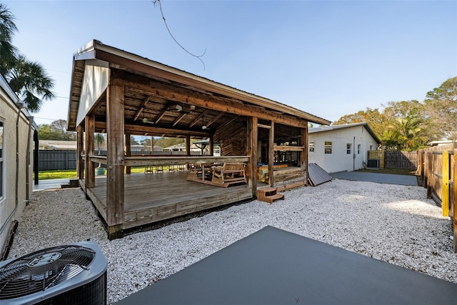 exterior space featuring a fenced backyard and central AC unit