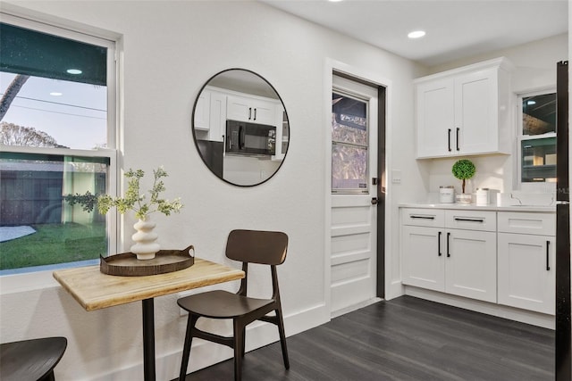 interior space with baseboards, dark wood finished floors, and recessed lighting