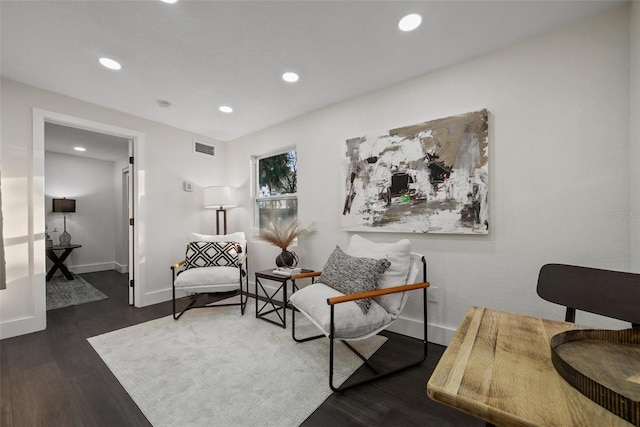 living area with recessed lighting, visible vents, baseboards, and wood finished floors