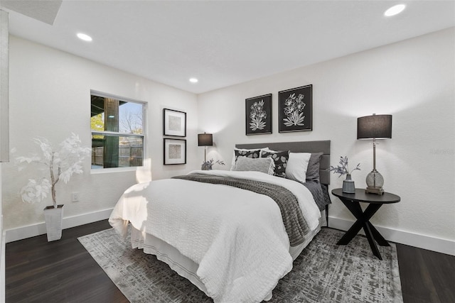 bedroom featuring baseboards, dark wood finished floors, and recessed lighting