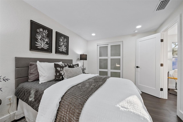 bedroom with dark wood-type flooring, visible vents, and recessed lighting