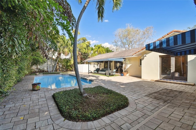 view of pool featuring a patio, an outdoor living space, and french doors