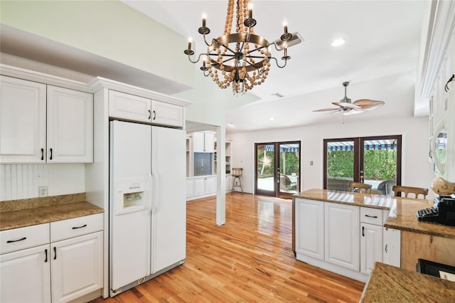 kitchen with white cabinetry, hanging light fixtures, white fridge with ice dispenser, light hardwood / wood-style floors, and french doors