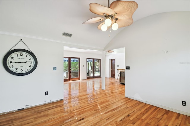 unfurnished room featuring lofted ceiling, light wood-type flooring, ceiling fan, and french doors