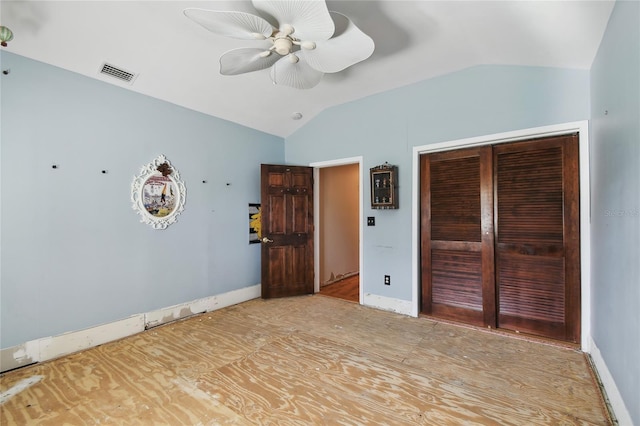 unfurnished bedroom featuring lofted ceiling, ceiling fan, and a closet