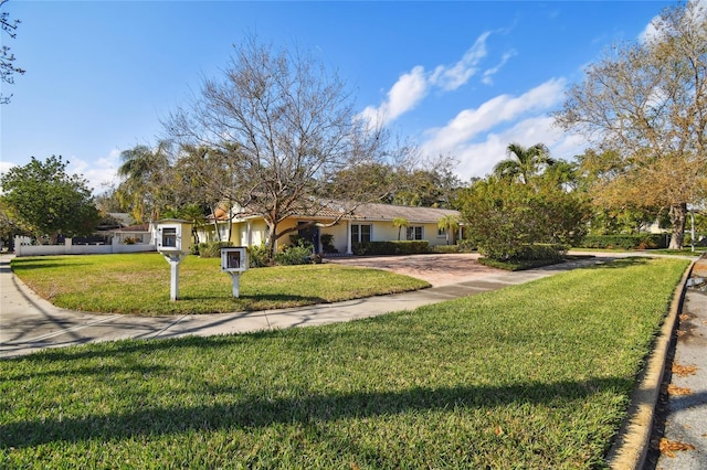 ranch-style house featuring a front lawn