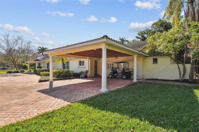 exterior space with a yard and a carport