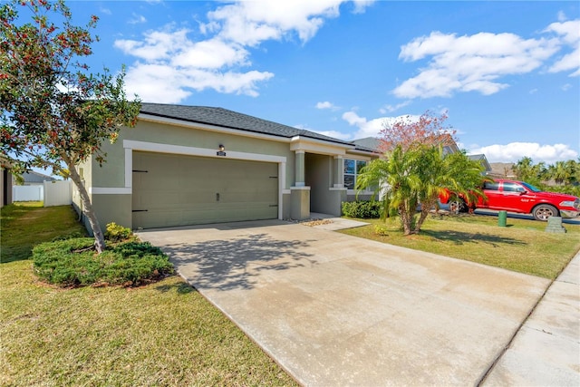 view of front of property with a garage and a front lawn