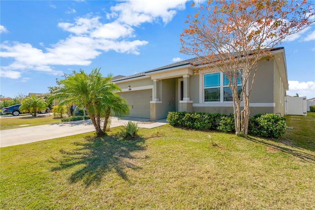 view of front of home featuring a garage and a front yard