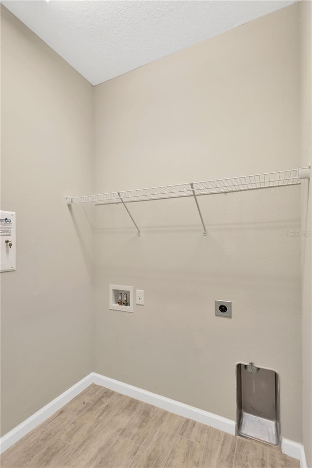 washroom with hardwood / wood-style floors, hookup for a washing machine, and hookup for an electric dryer