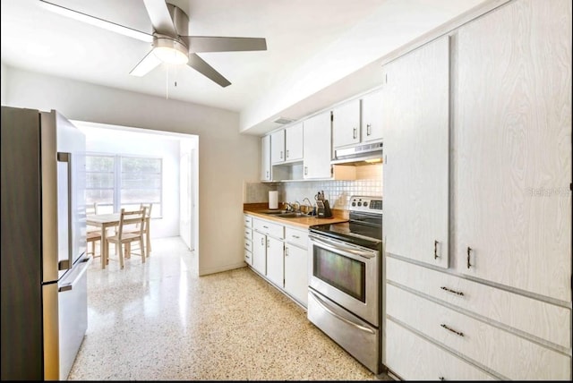 kitchen with sink, tasteful backsplash, appliances with stainless steel finishes, ceiling fan, and white cabinets