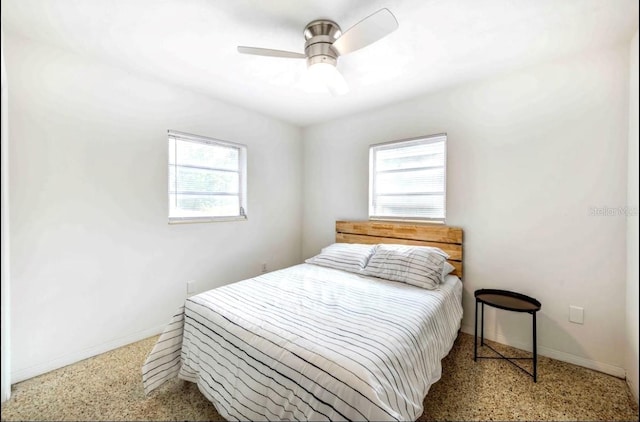 bedroom featuring multiple windows and ceiling fan