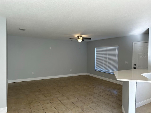 interior space featuring a textured ceiling and ceiling fan