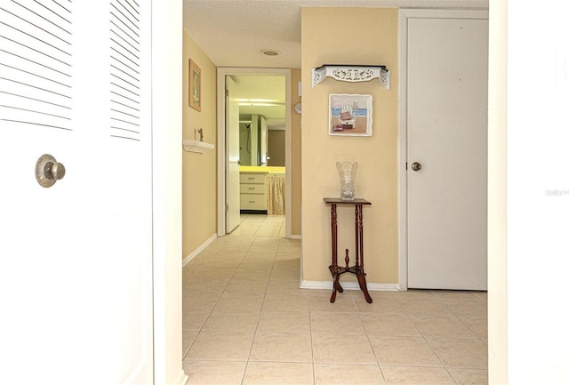 corridor featuring light tile patterned floors