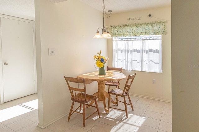 tiled dining room with a textured ceiling