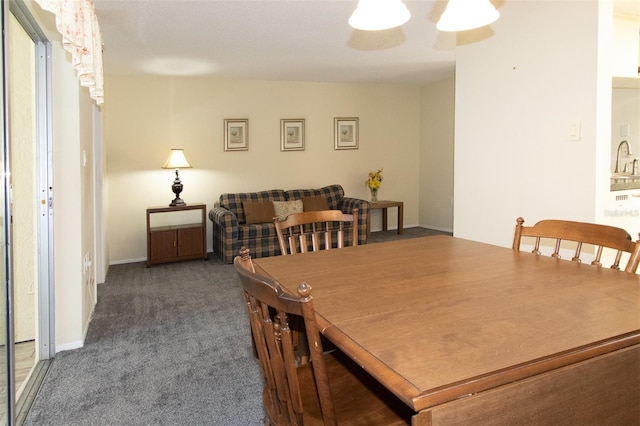 dining space with dark colored carpet