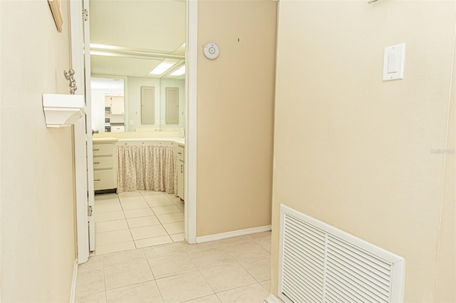 hall featuring light tile patterned flooring