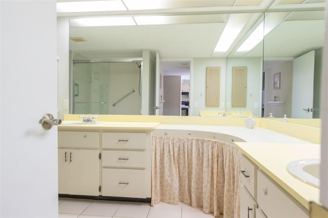 bathroom with walk in shower, tile patterned floors, and vanity