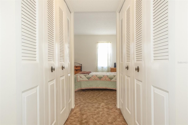 hallway with light colored carpet