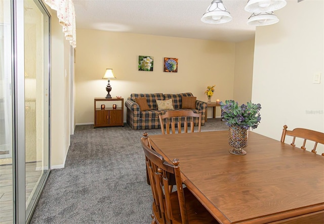 carpeted dining area with a textured ceiling