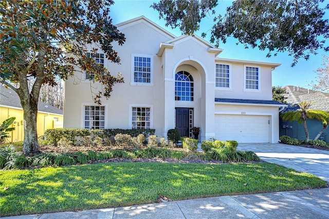 view of front of house with a garage and a front yard