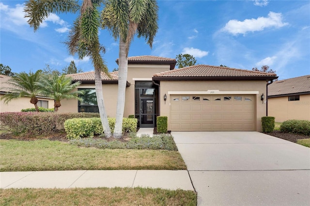 mediterranean / spanish house with a garage and a front lawn