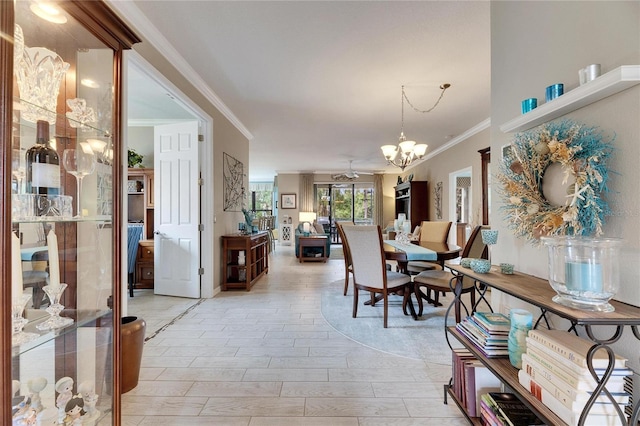 dining area featuring ornamental molding, ceiling fan with notable chandelier, and light hardwood / wood-style flooring