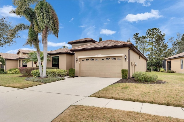 mediterranean / spanish home with a garage and a front lawn