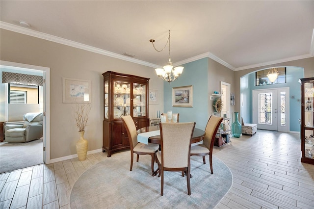 dining room with an inviting chandelier and ornamental molding