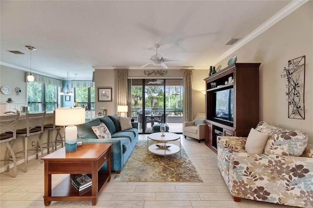 living room with ceiling fan, ornamental molding, and light hardwood / wood-style floors