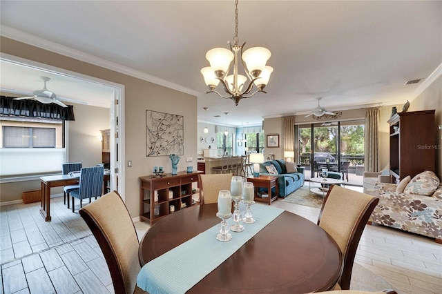 dining area with crown molding and ceiling fan with notable chandelier