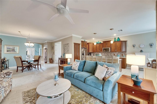 living room with crown molding, ceiling fan with notable chandelier, and light hardwood / wood-style floors