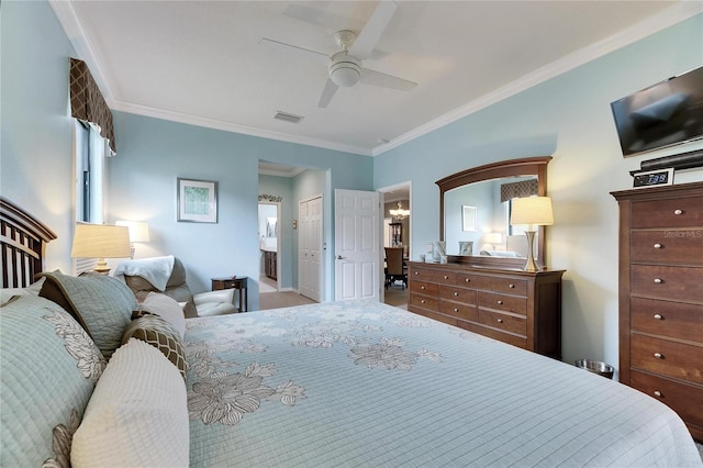 bedroom featuring crown molding, ensuite bath, ceiling fan, and a closet