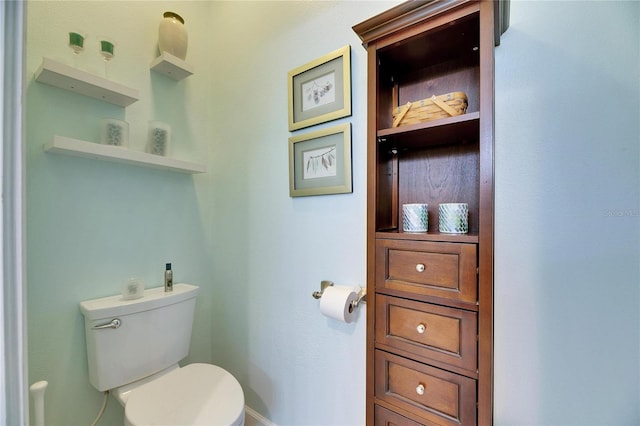 bathroom with built in features and toilet