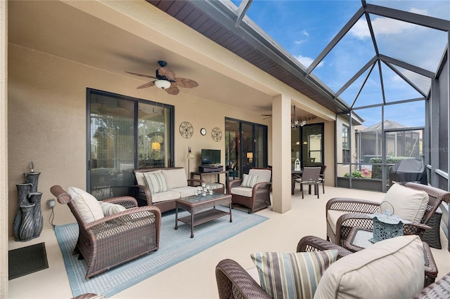 exterior space featuring an outdoor living space, ceiling fan, and glass enclosure