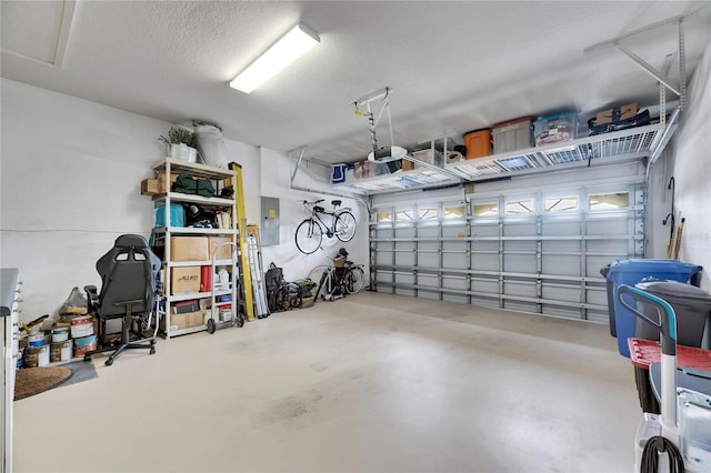 garage featuring a garage door opener and electric panel