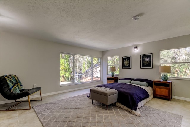 bedroom with light tile patterned floors and a textured ceiling