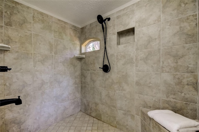 bathroom featuring tiled shower and a textured ceiling