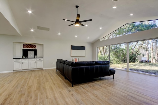 living room with high vaulted ceiling, light hardwood / wood-style flooring, and ceiling fan