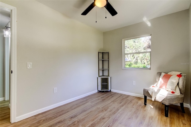 sitting room with light wood-type flooring and ceiling fan