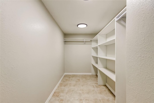 spacious closet with light tile patterned floors