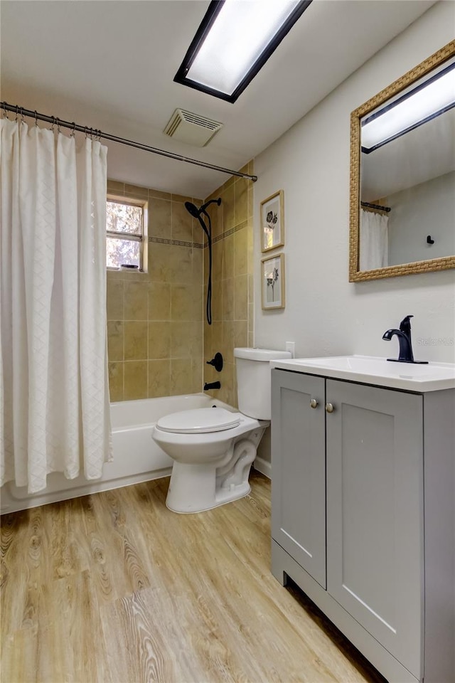 full bathroom with shower / bath combo with shower curtain, vanity, toilet, and wood-type flooring