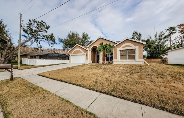 ranch-style home with a garage and a front yard