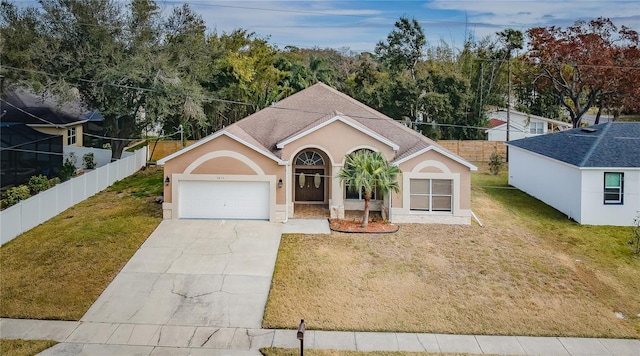 view of front of property with a garage and a front lawn