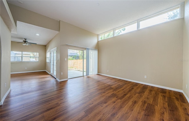 unfurnished room with ceiling fan, dark hardwood / wood-style flooring, and high vaulted ceiling