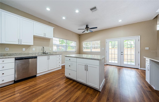 kitchen with white cabinetry, stainless steel dishwasher, dark wood-type flooring, and sink