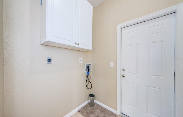 clothes washing area featuring washer hookup, cabinets, and hookup for an electric dryer