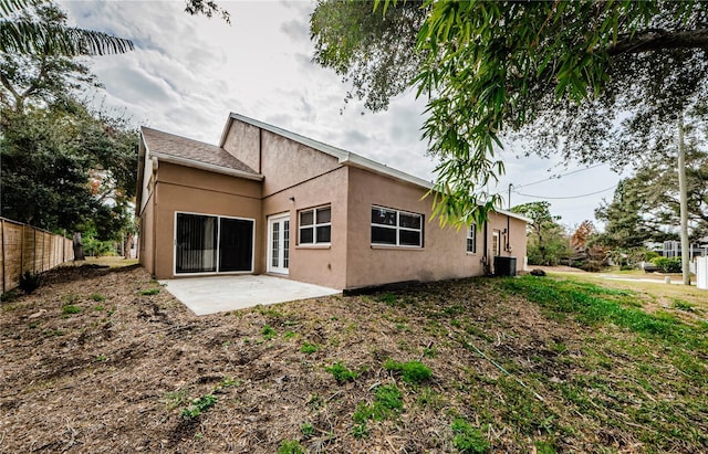 rear view of property featuring central AC unit and a patio