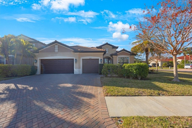 view of front of home featuring a garage and a front lawn